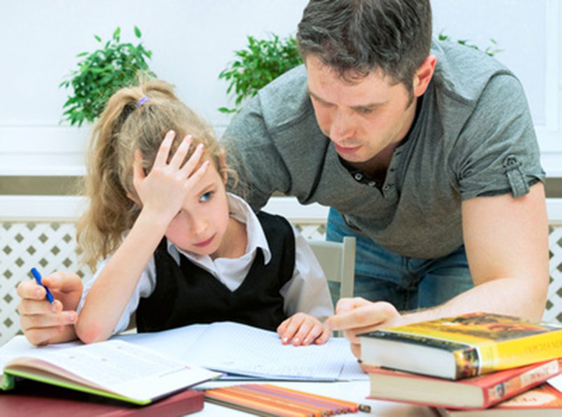 Pushy parents; dad helping daughter with homework at home