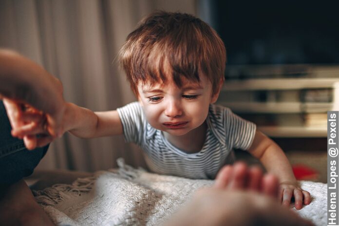 Close-Up of toddlers wake up at night in a striped shirt crying