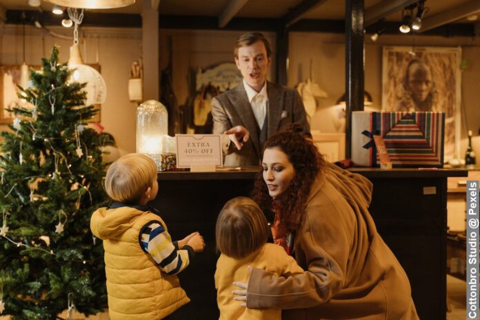A store manager serving a family inside the store Christmas shopping