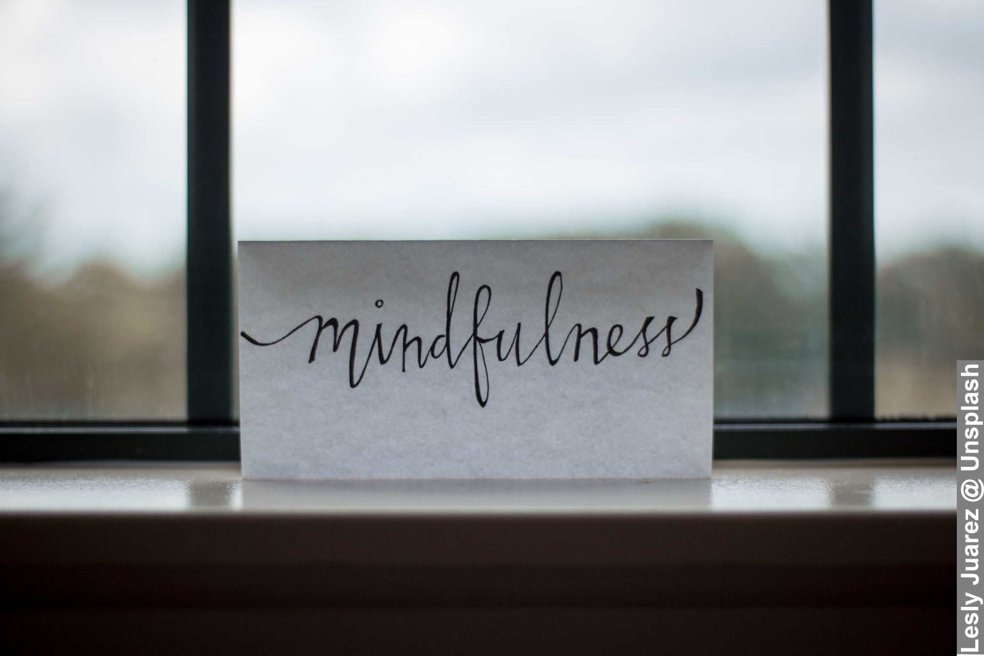 Practice mindfulness and Wellness in words by window