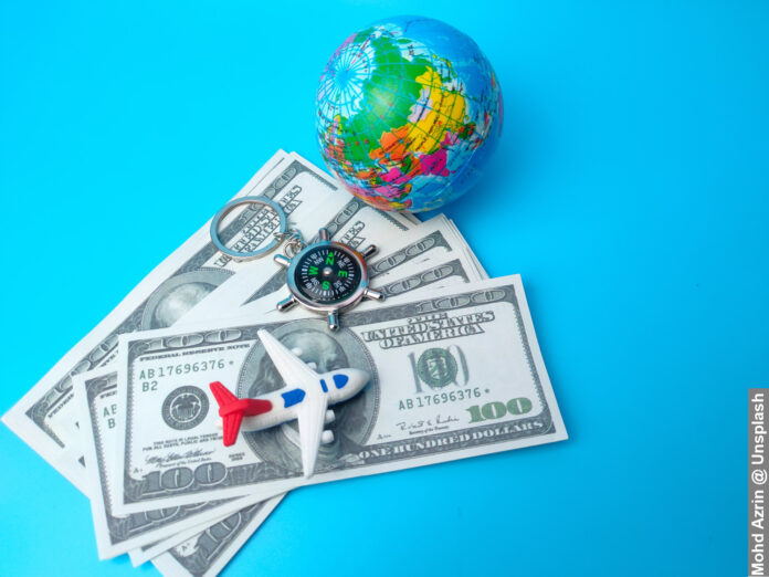 Spending Money on Family Holidays With Dolla Bills, Plane and Globe