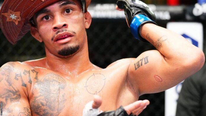 In this image related to Igor Severino's UFC disqualification for biting, Andre Lima points to the visible bite marks on his arm, which were inflicted by Igor Severino during their controversial UFC fight