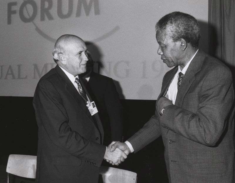 Nelson Mandela and Frederik de Klerk shaking hands at the World Economic Forum meeting